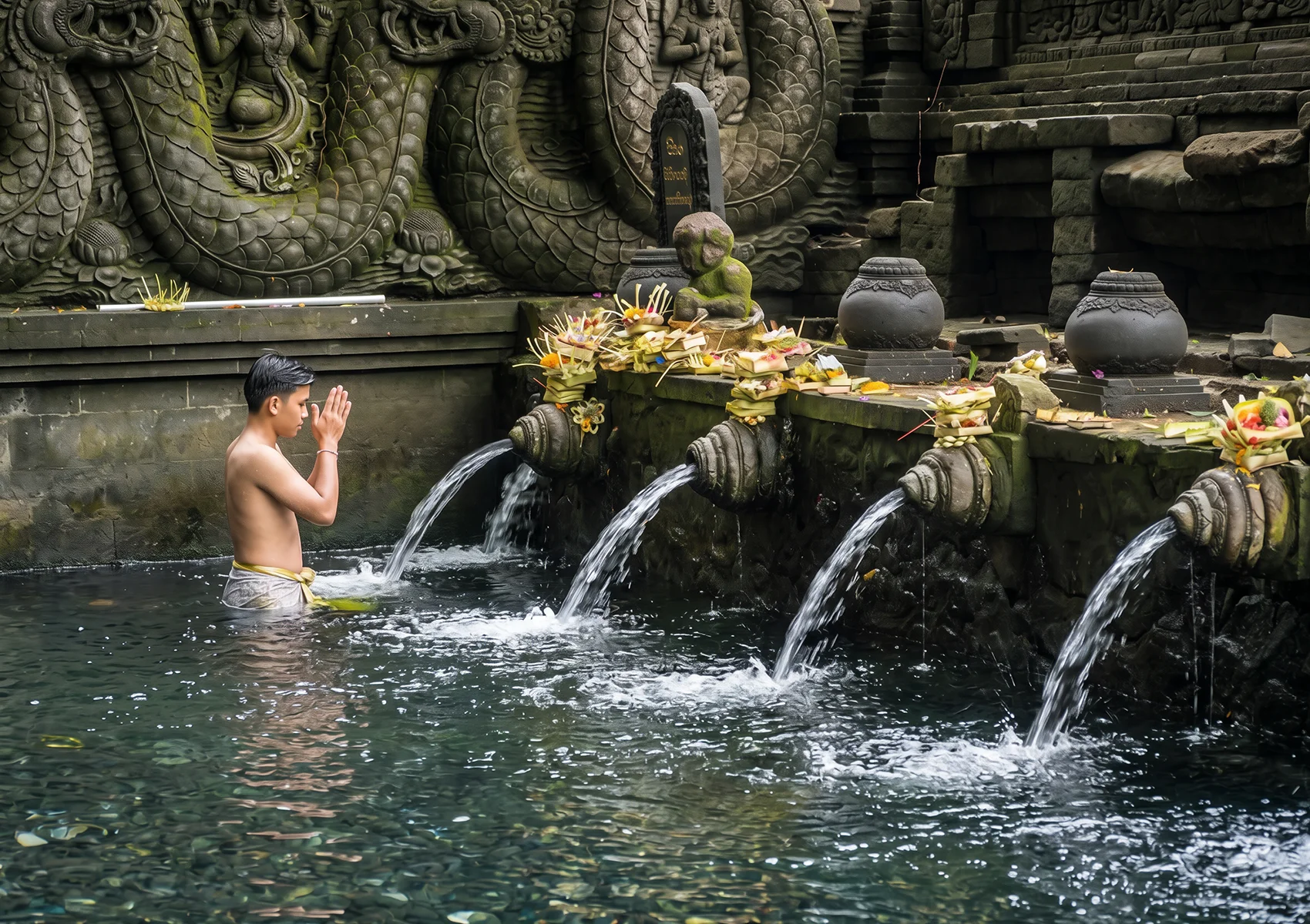 Balinese Hindu purification ritual at a sacred water temple during a traditional Melukat ceremony in Bali.