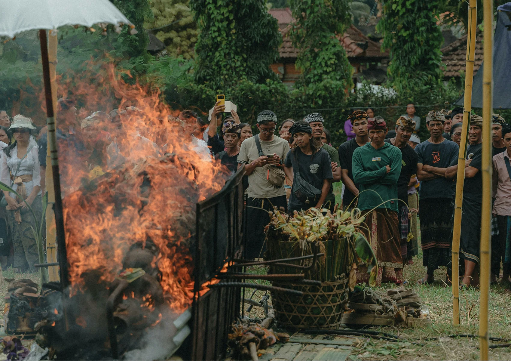 Balinese Hindu cremation ceremony with sacred fire ritual and local community gathering during a traditional Ngaben ceremony in Bali.